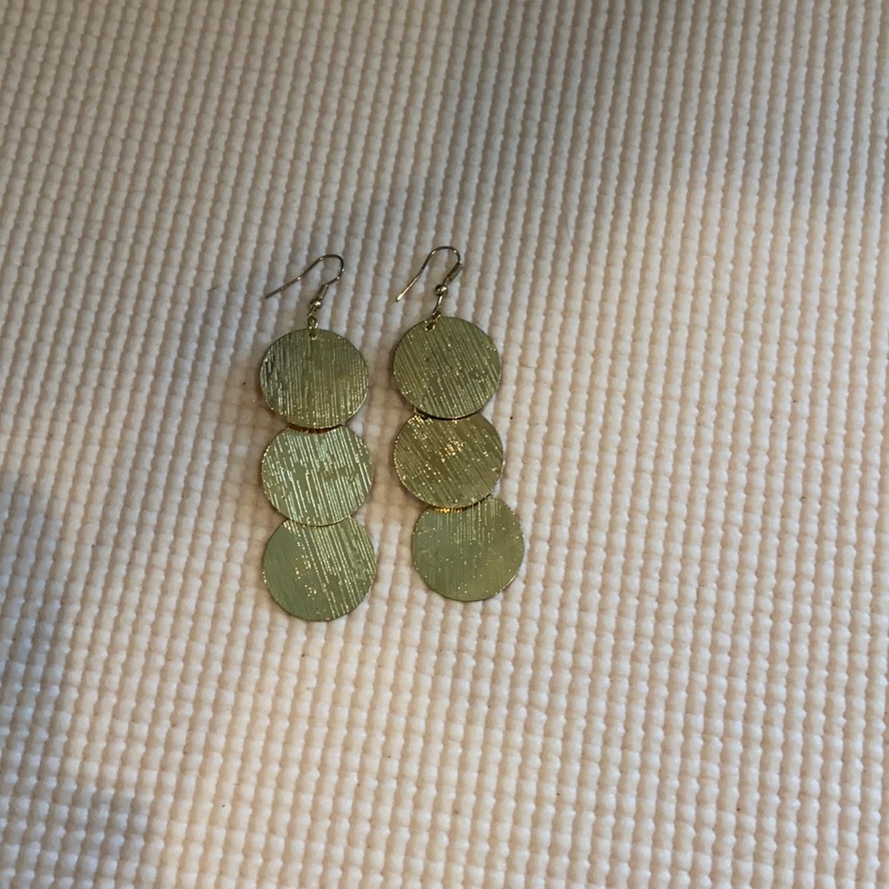 Long gold circle dangling earrings.